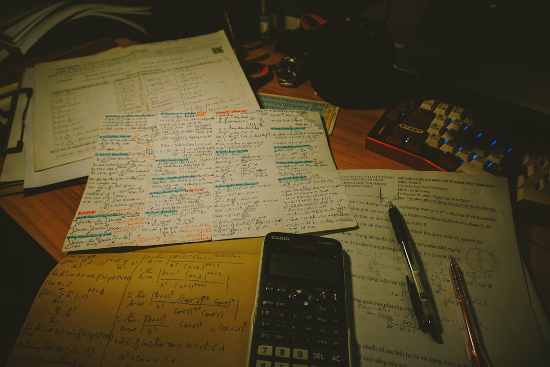A clean, minimalist overhead shot of a desk with a calculator and a pen resting on organized financial paperwork, representing clarity and control over closing costs.