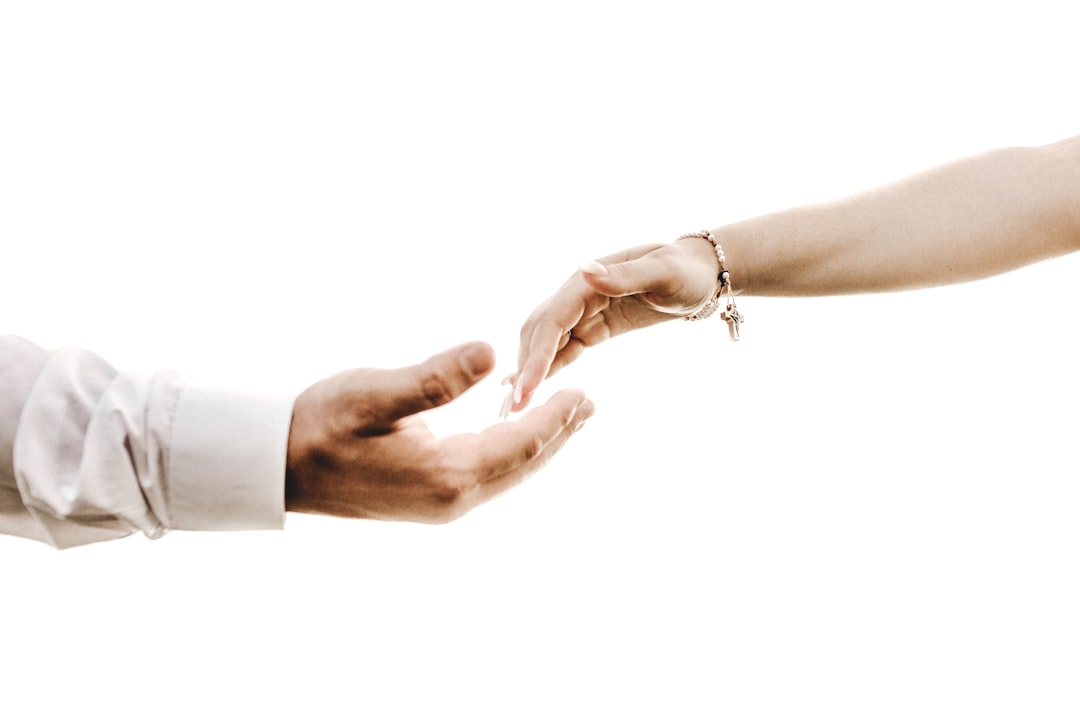 A close-up shot of a real estate agent's hands giving a set of house keys to a new homeowner, symbolizing a successful and valuable transaction.