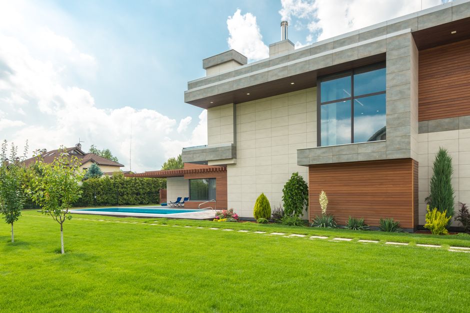 The stunning exterior of a modern luxury home on a bright, sunny day, showcasing the high-value properties available in the Keswick real estate market.