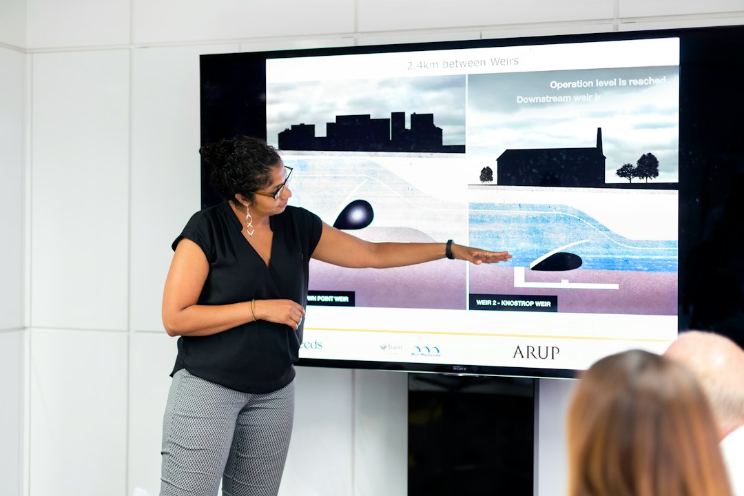 A real estate professional analyzing complex, abstract data on a large screen, representing the use of AI-powered personalization and market analysis.